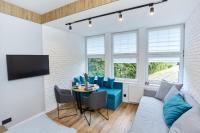 Televízia a/alebo spoločenská miestnosť v ubytovaní Apartament "Powoli" z darmowym parkingiem