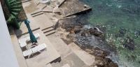 an aerial view of chairs and the water at Apartments by the sea Pisak, Omis - 1018 in Pisak