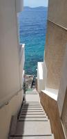 a stairway leading down to the ocean from a building at Apartments by the sea Pisak, Omis - 1018 in Pisak