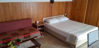 a bedroom with a bed and a table with flowers on it at Apartments by the sea Pisak, Omis - 1018 in Pisak