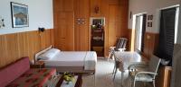 a bedroom with a bed and a table and chairs at Apartments by the sea Pisak, Omis - 1018 in Pisak