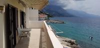 a balcony of a building with a view of the water at Apartments by the sea Pisak, Omis - 1018 in Pisak