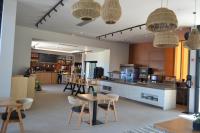 a restaurant with tables and chairs in a room at Cook's Club Ialysos Rhodes in Ialyssos