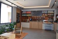 a bar in a restaurant with a counter and a table at Cook's Club Ialysos Rhodes in Ialyssos