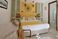 a bedroom with two beds and a couch in it at Lodge de Charme A Cheda in Bonifacio