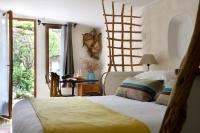a bedroom with a bed with a ladder on the wall at Lodge de Charme A Cheda in Bonifacio