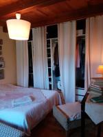 a bedroom with a bed and a table with a lamp at Comfortable Quiet House in the countryside Porte-du-Quercy for 8 people in Sérignac