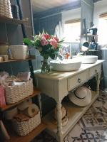 a bathroom with two sinks and a vase of flowers at Comfortable Quiet House in the countryside Porte-du-Quercy for 8 people in Sérignac