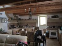 a living room with a couch and a table with chairs at Comfortable Quiet House in the countryside Porte-du-Quercy for 8 people in Sérignac