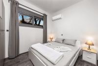 A bed or beds in a room at East Coast Apartment Ilios Rhodes