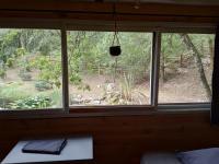 a window in a room with a view of a forest at Echappée sauvage in Masquières