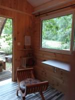 a log cabin with a bench and a window at Echappée sauvage in Masquières