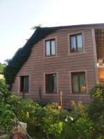 a house with ivy growing on the side of it at Roin Guest House in Grigoleti