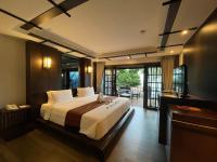 a bedroom with a large bed and a balcony at Panviman Resort Koh Phangan - SHA Extra Plus in Thong Nai Pan Noi