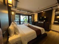 a bedroom with a large bed with a large window at Panviman Resort Koh Phangan - SHA Extra Plus in Thong Nai Pan Noi