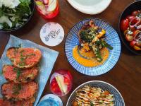 a table topped with plates of food and bowls of food at InterContinental Perth City Centre by IHG in Perth