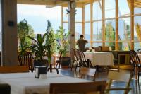 Apricot Hotel Yerevan في يريفان: رجل يقف على طاولة في مطعم