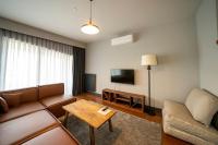 a living room with a couch and a tv at Superior, classy residence,7&#47;24 Security,2 bedroom ( Benesta 205 ) in Istanbul