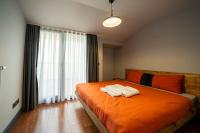 a bedroom with an orange bed with two towels on it at Superior, classy residence,7&#47;24 Security,2 bedroom ( Benesta 205 ) in Istanbul