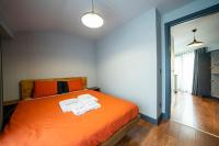 a bedroom with an orange bed with two towels on it at Superior, classy residence,7&#47;24 Security,2 bedroom ( Benesta 205 ) in Istanbul