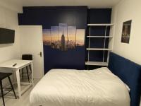 a room with a bed and a desk and a ladder at Lh Rooms Location in Le Havre