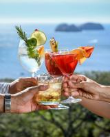 a group of people holding up their drinks at Villas Sol Beach Resort in Playa Hermosa