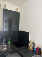 a kitchen counter with a sink and a mirror at Cocon Accès facile Parking Gratuit in Belfort