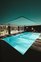 a large swimming pool with chairs in a building at Domaine Des Hautes Fagnes in Ovifat