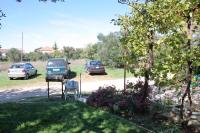 a yard with two cars parked in a parking lot at Apartments with a parking space Bibinje, Zadar - 5753 in Bibinje