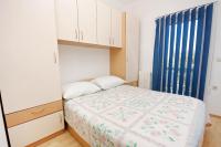 a small bedroom with a bed and a window at Apartments with a parking space Bibinje, Zadar - 5753 in Bibinje