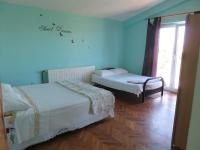 two beds in a room with blue walls at Apartments with a parking space Bibinje, Zadar - 5753 in Bibinje