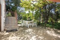 a patio with a table and chairs and trees at Apartments with a parking space Bibinje, Zadar - 5753 in Bibinje