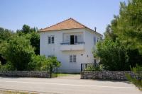 a white house with a balcony on a street at Family Room Drace 4550a in Drače