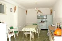 a kitchen with a table and chairs in a room at Family Room Drace 4550a in Drače
