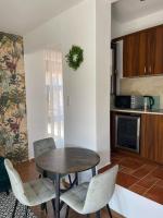 A kitchen or kitchenette at Fit Paradise Apartman