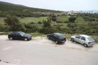 two cars parked on the side of a road at Apartments with a parking space Sveti Petar, Biograd - 6169 in Sveti Petar