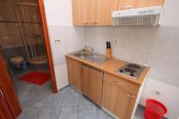 a small kitchen with a sink and a stove at Apartments with a parking space Sveti Petar, Biograd - 6169 in Sveti Petar