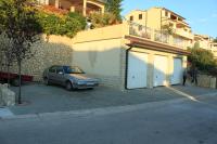 a car parked in a parking lot next to a building at Apartments with a parking space Rabac, Labin - 7442 in Rabac