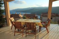 a table and chairs on a balcony with a view at Apartments with a parking space Rabac, Labin - 7442 in Rabac