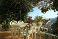 a white table and chairs on a patio with a view at Apartments with a parking space Rabac, Labin - 7442 in Rabac