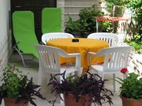 a table and four chairs with a yellow table and some plants at Apartments with a parking space Rabac, Labin - 7442 in Rabac