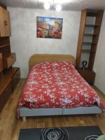 a bedroom with a bed with a red blanket at Studio indépendant dans un maison in Saint-Denis