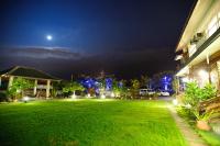 a large yard with a green lawn at night at Bay of Stars in Ji&#39;an