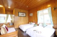 two beds in a room with wood paneled walls at Bay of Stars in Ji&#39;an