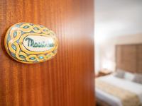 A bed or beds in a room at Kalamarina Rooms