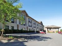 Un edificio con un coche aparcado en un estacionamiento. en Quality Inn &amp; Suites Boone - University Area, en Boone