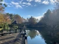 a view of a river with a bridge and benches at Fanlin House in Jialin