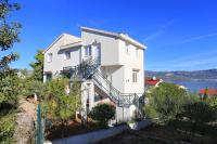 a white house with stairs and a view of the water at Apartments by the sea Slatine, Ciovo - 9433 in Trogir