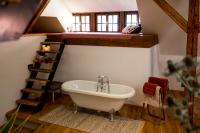 a bathroom with a white bath tub in a attic at Studio Loft Murau - im Herzen der Altstadt in Murau
