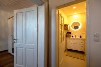 a hallway with a white door and a sink at Studio Loft Murau - im Herzen der Altstadt in Murau